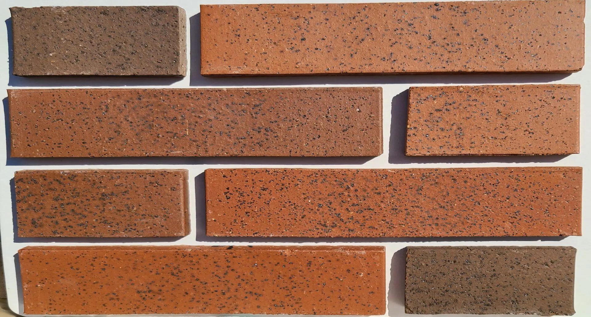 The view of a wall with various shade of red bricks