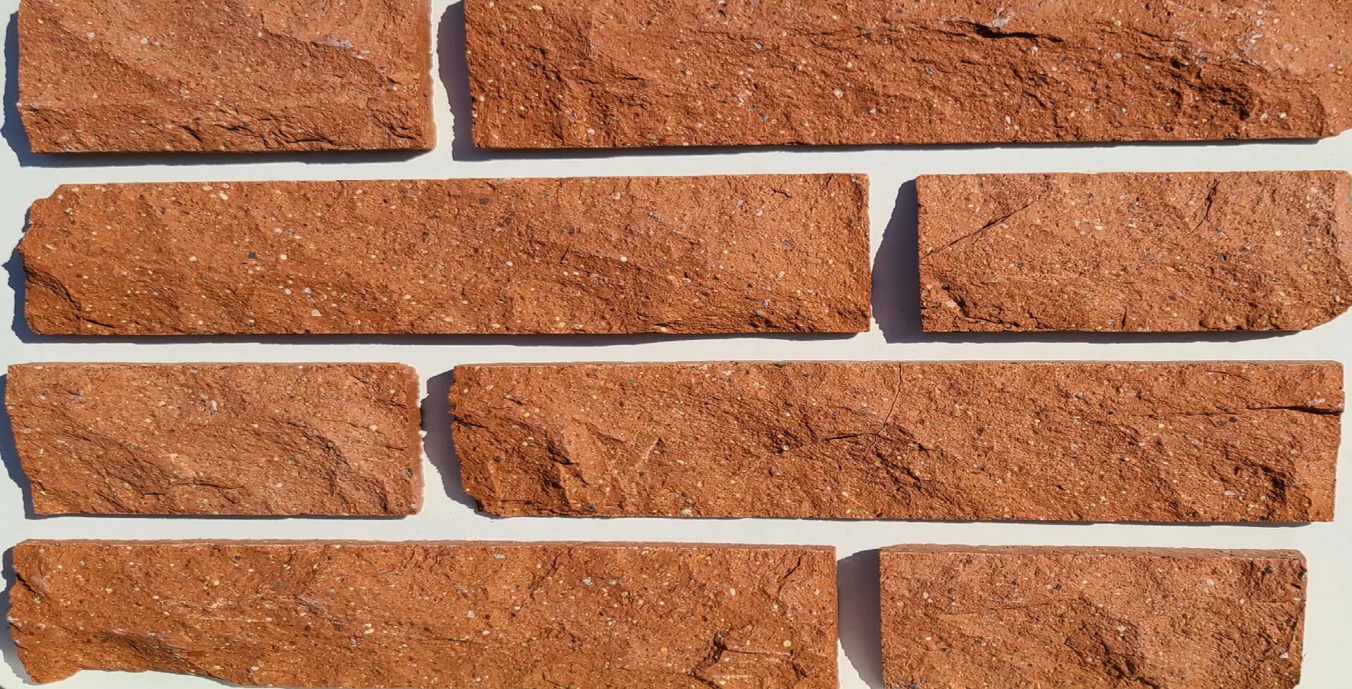 The close up view of dark red common brick wall